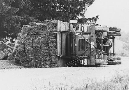 hay truck tipped over - Whoops! Just another day at the ranch.